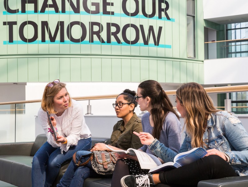 People sitting on sofa talking on RGU campus