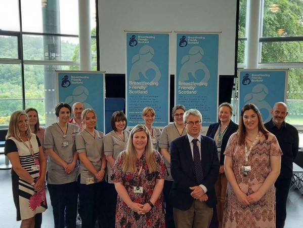 Group of people and nurses pose for a photograph