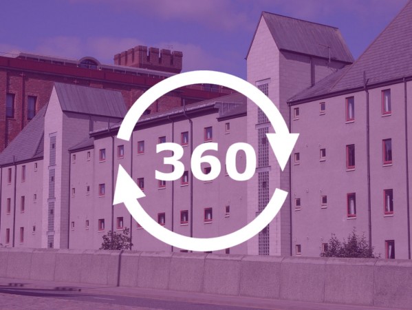 360 graphic image with circular arrows and Woolmanhill Flats accommodation in the background