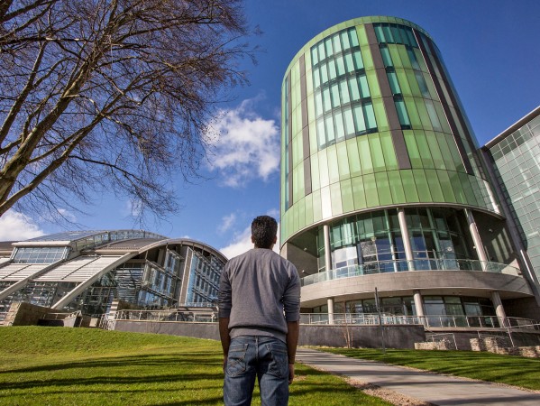 person looking up at the library tower on the rgu campus