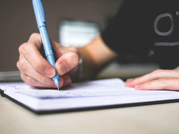 person writing in a notebook