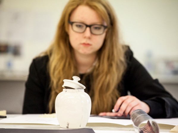 student looking at ceramic sculpture