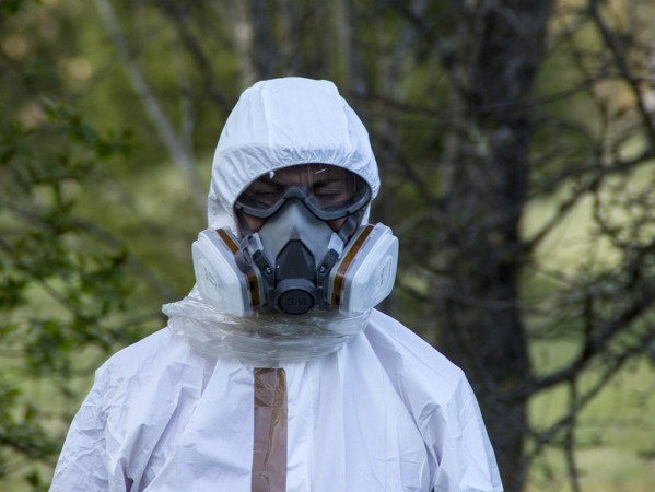 Person in protective clothing and mask Person in protective clothing and mask