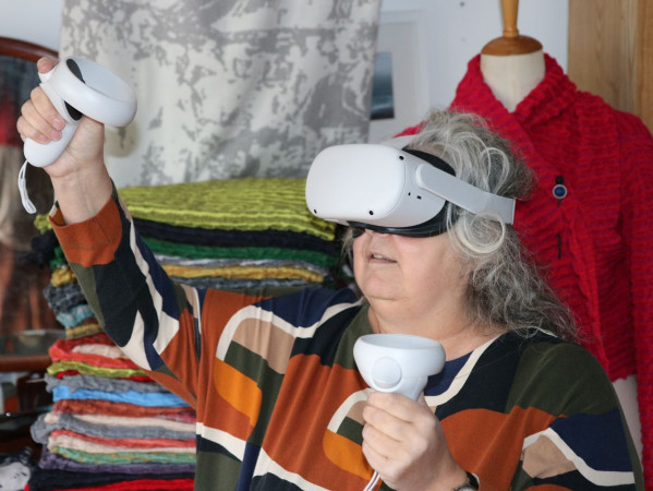 Person using augmented reality headset with textiles around them
