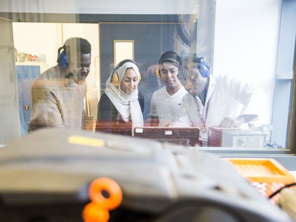 Students wearing ear defenders looking at some equiptment