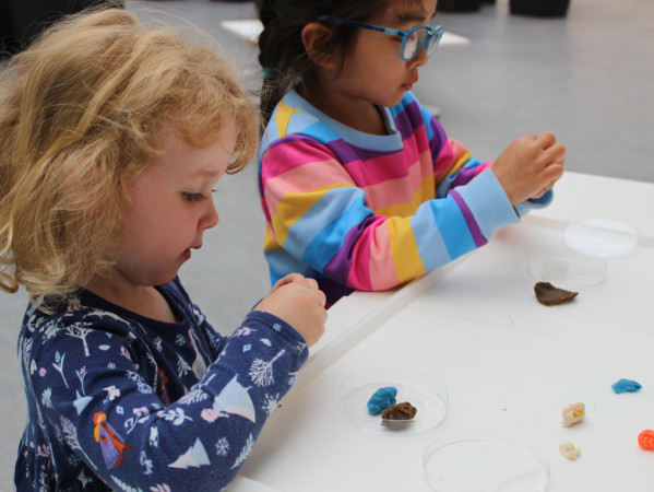 Two nursery children playing with science Two nursery children playing with science