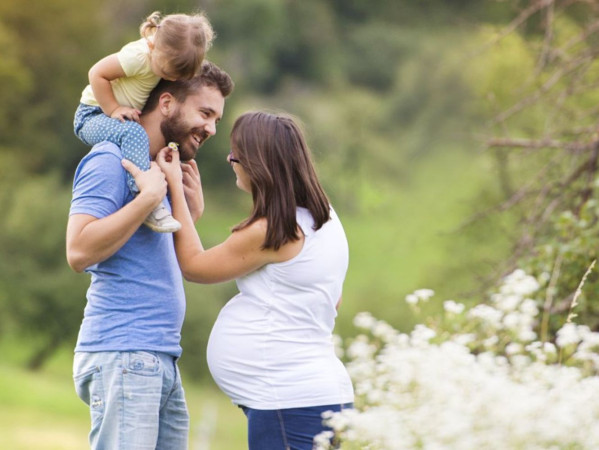 Image shows man with child on his shoulders and expectant mother, from Birth of Brilliance Image shows man with child on his shoulders and expectant mother, from Birth of Brilliance