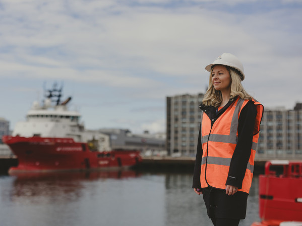 Person wearing a high-vis jacket and hard hat at Aberdeen Harbour