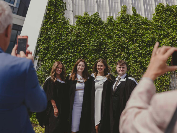 family taking photos of graduates family taking photos of graduates