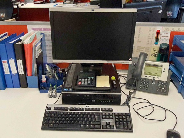 a desk with pc and folders