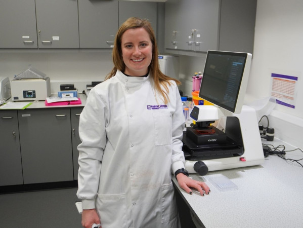 Dr Gael Morrow wearing a white coat in a lab Dr Gael Morrow wearing a white coat in a lab