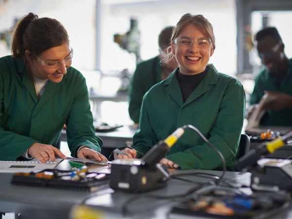 Students in Green Overalls laughing