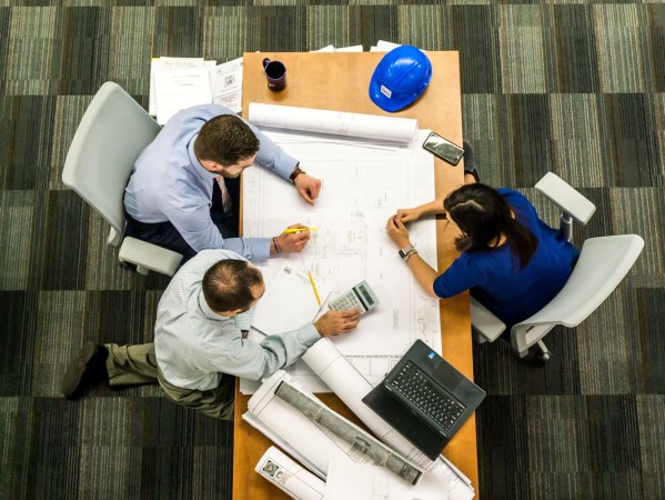 top view of people in a meeting over a desk