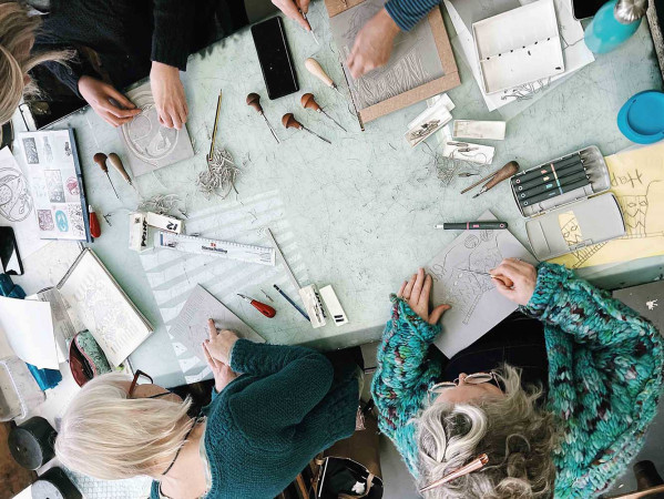 People lino cutting - view from above