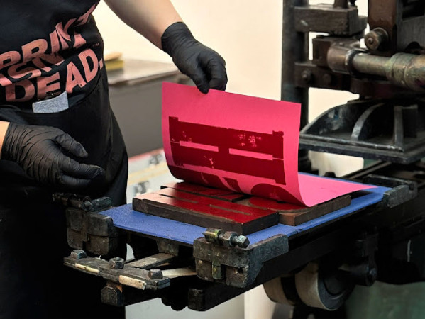 a letter press print being made