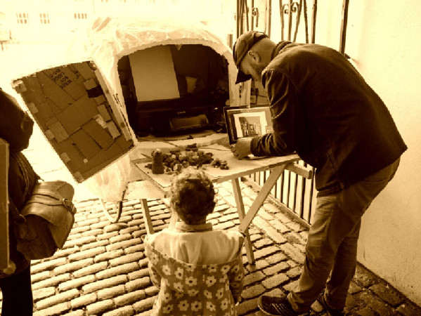 Sepia toned image of people making models