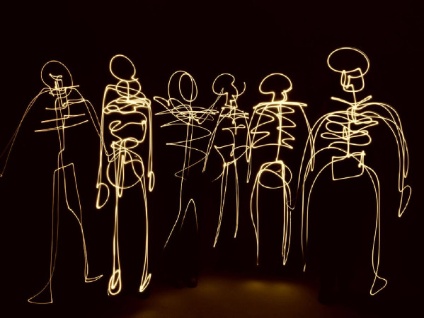Sepia toned image of skeletons made from light streams