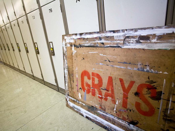 An art board with the word Grays sprayed on to it in red paint