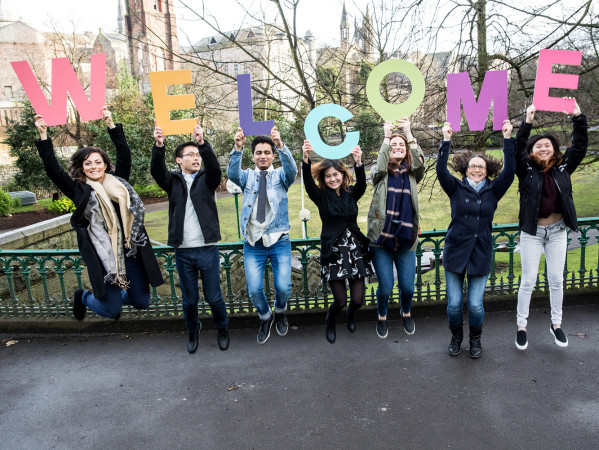 International Students holding up letters spelling Welcome International Students holding up letters spelling Welcome