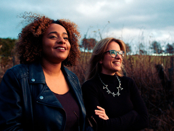 Two people standing in a field