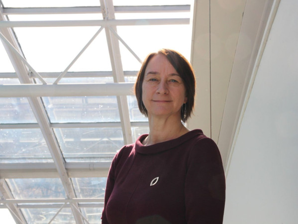 Janine Bolger stands next to a bright window