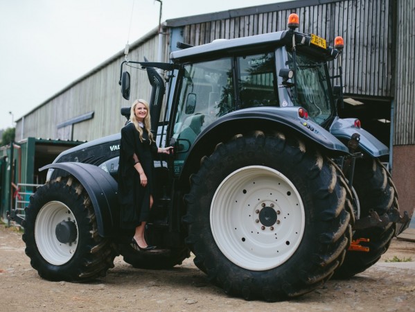 Graduate standing on tractor