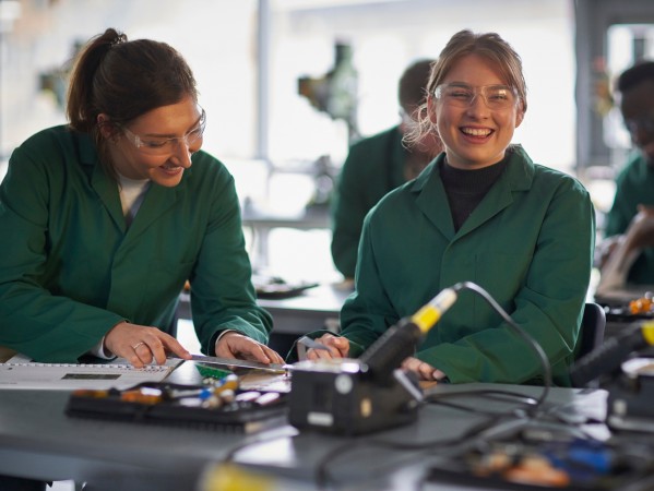 students in green work coats