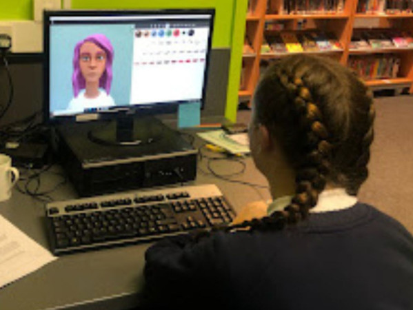 Image shows school pupil looking at a computer screen with the Maddie is Online programme Image shows school pupil looking at a computer screen with the Maddie is Online programme