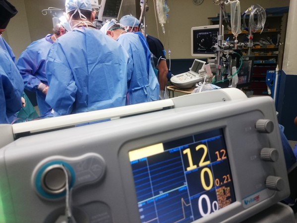 doctors in blue gowns in an operating theatre