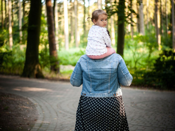 Image shows a women carrying a child on their shoulder - credit ECPO European Coalition for People with Obesity