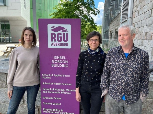 Image shows( left to right) artist, Victoria Fifield from the ‘No Place Like Home’ exhibition for The Open Road, Dr Lucia Ruggerone from The School of Applied Social Sciences and Charles Hackett, lecturer from Gray’s School of Art.