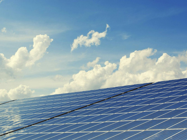 A solar panel board with a blue sky A solar panel board with a blue sky