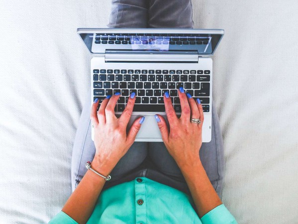 person typing on a laptop