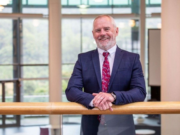 RGU Principal Professor Steve Olivier standing smiling