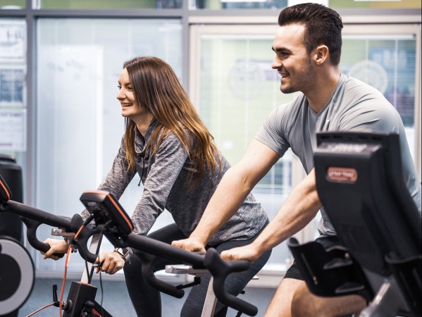 smiling students on cycling machines
