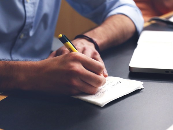 person writing in a notebook