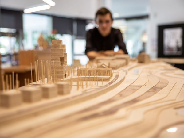 Image shows architectural students looking at a model in the Scott Sutherland School of Architecture at RGU