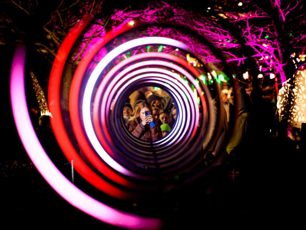 Image shows Spectra 2023 opening festival, women with phone looking through light display - Credit Ian Georgeson Image shows Spectra 2023 opening festival, women with phone looking through light display - Credit Ian Georgeson