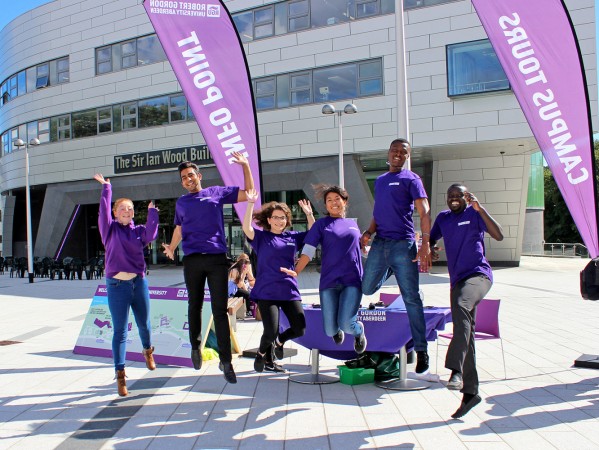 RGU student ambassadors jumping in the air outside sir ian wood building