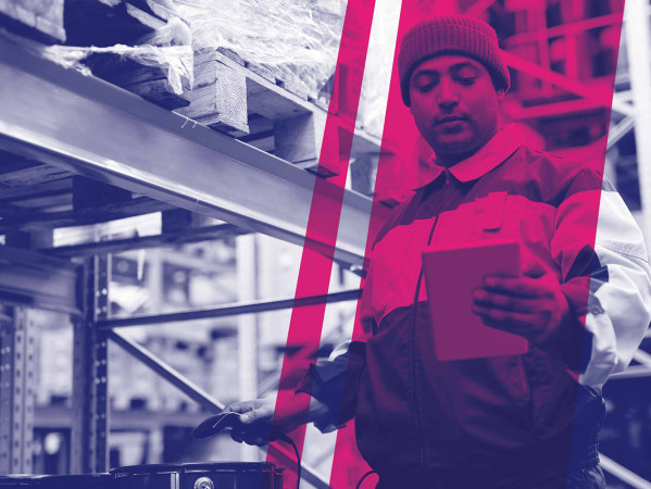 Person in workshop reading from a notebook