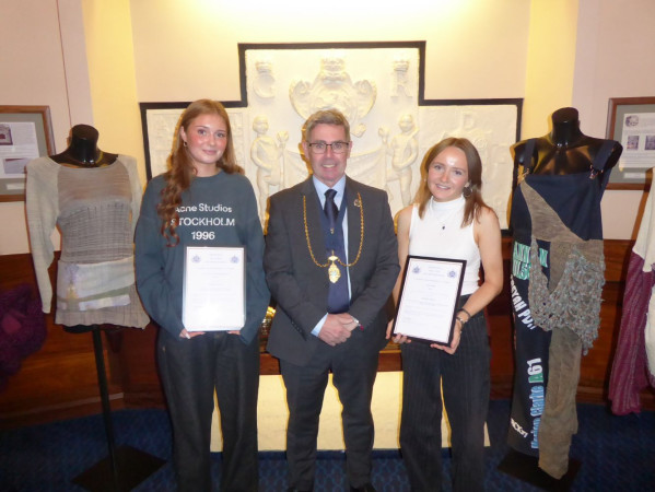 Award winners holding their certificate