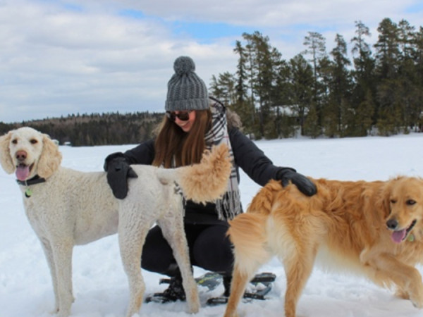 Taylor Fraser in snow with two dogs