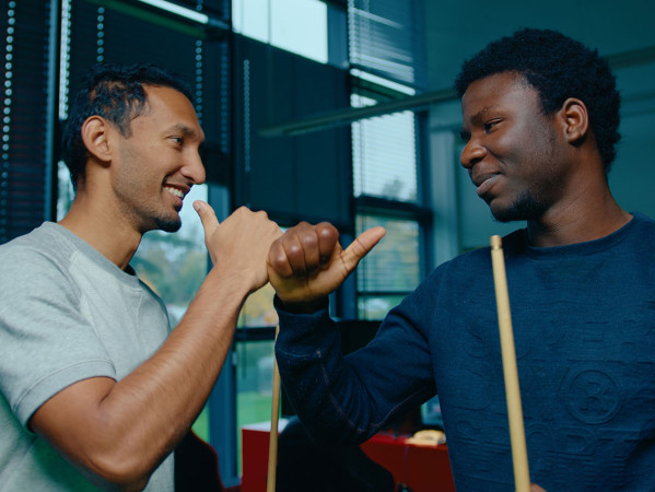 two students playing pool