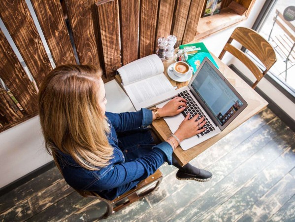 student working on a laptop in a cafe