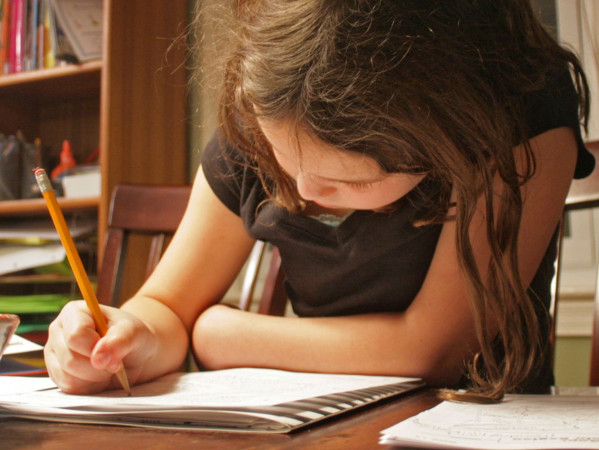 A young female being home-schooled during lockdown