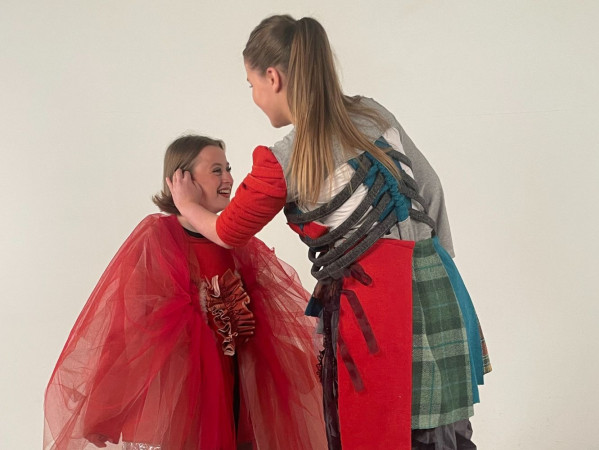 Image shows two fashion students from Gray's School of Art preparing costumes for fashion show