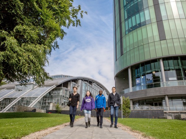 students walking outside the riverside building