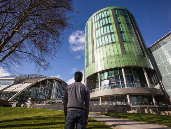 person looking up at the library tower on the rgu campus