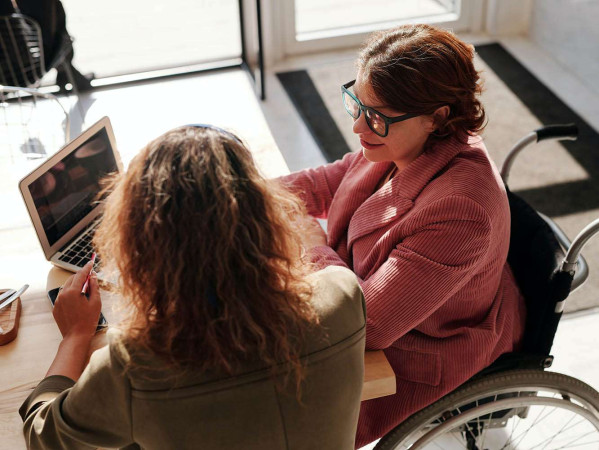 woman in wheelchair in a meeting