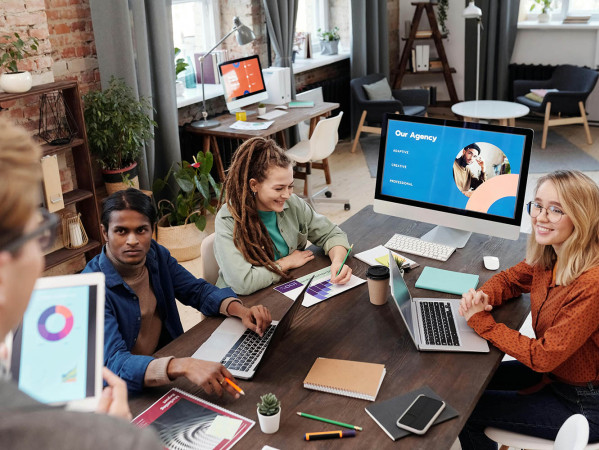 people at a computer having a meeting